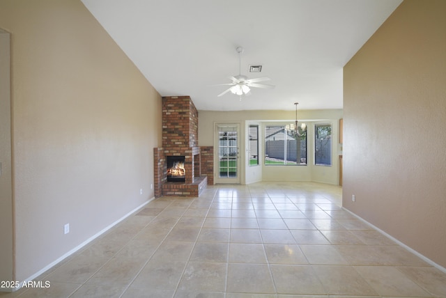 unfurnished living room with light tile patterned flooring, ceiling fan with notable chandelier, a fireplace, visible vents, and vaulted ceiling