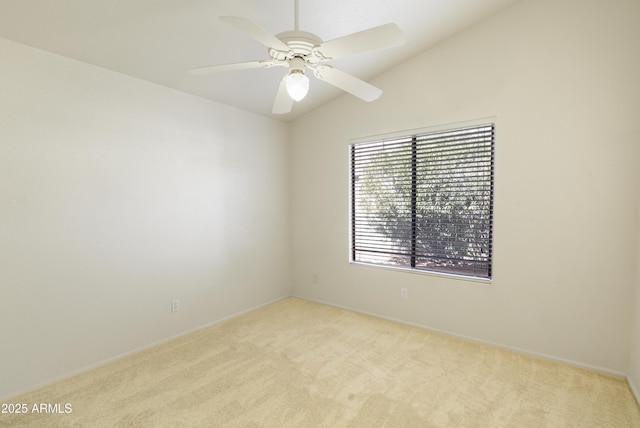 carpeted empty room featuring ceiling fan and vaulted ceiling