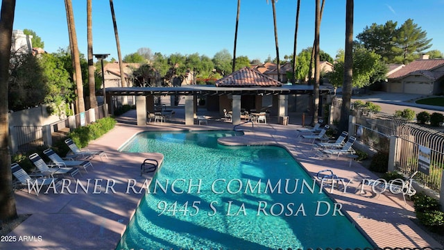 community pool featuring a patio area and fence