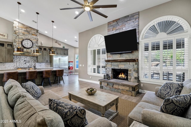 26475 N Wrangler Rd, Scottsdale, AZ 85255 - living room with ceiling fan, light wood-style floors, high vaulted ceiling, a stone fireplace, and recessed lighting