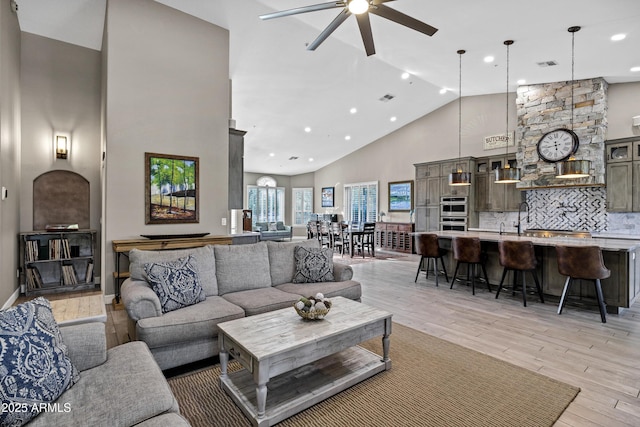 26475 N Wrangler Rd, Scottsdale, AZ 85255 - living room with high vaulted ceiling, ceiling fan, light wood-style flooring, and recessed lighting