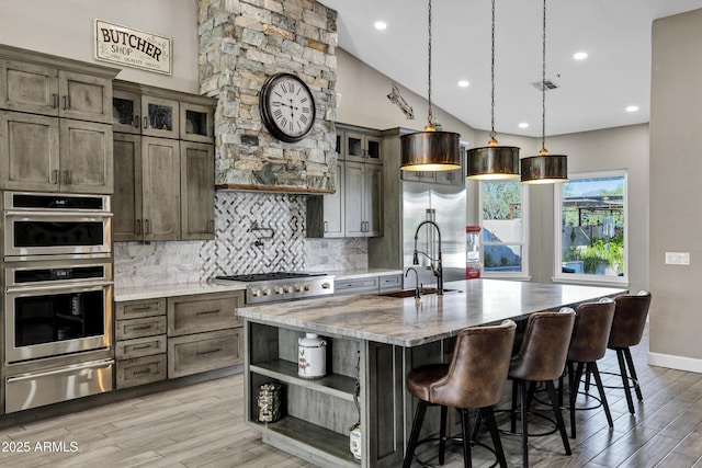 26475 N Wrangler Rd, Scottsdale, AZ 85255 - kitchen with a warming drawer, appliances with stainless steel finishes, open shelves, tasteful backsplash, and light wood-style floors
