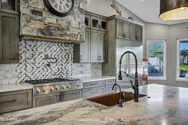 26475 N Wrangler Rd, Scottsdale, AZ 85255 - kitchen featuring stainless steel gas stovetop, tasteful backsplash, extractor fan, and light stone counters