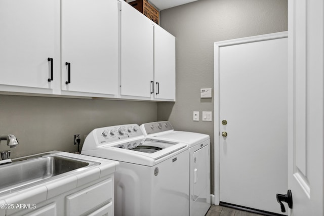 26475 N Wrangler Rd, Scottsdale, AZ 85255 - laundry area with separate washer and dryer, cabinet space, and wood finished floors