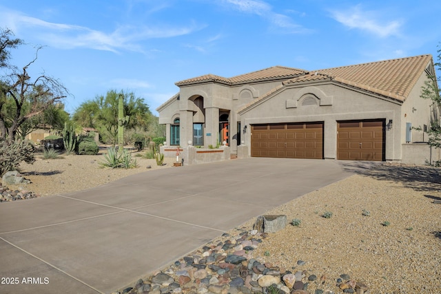 26475 N Wrangler Rd, Scottsdale, AZ 85255 - mediterranean / spanish house with concrete driveway, a garage, stucco siding, and a tiled roof