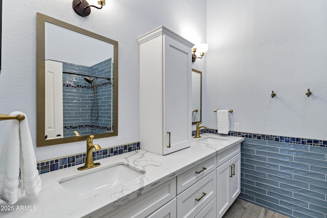 26475 N Wrangler Rd, Scottsdale, AZ 85255 - full bathroom with tile walls, double vanity, tiled shower, and a wainscoted wall