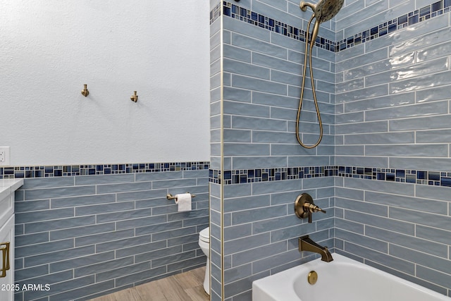 26475 N Wrangler Rd, Scottsdale, AZ 85255 - bathroom with bathing tub / shower combination, wood finished floors, and tile walls