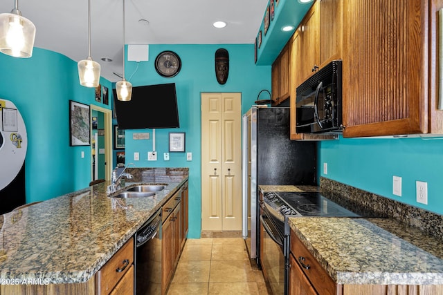26475 N Wrangler Rd, Scottsdale, AZ 85255 - kitchen with black appliances, brown cabinets, a peninsula, dark stone countertops, and hanging light fixtures
