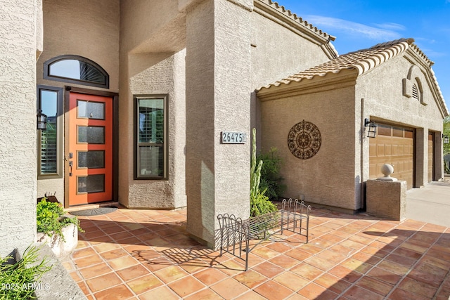 26475 N Wrangler Rd, Scottsdale, AZ 85255 - property entrance featuring stucco siding, a tile roof, and driveway