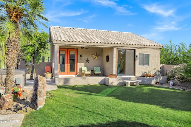 26475 N Wrangler Rd, Scottsdale, AZ 85255 - rear view of house featuring stucco siding, a tiled roof, ceiling fan, and a yard