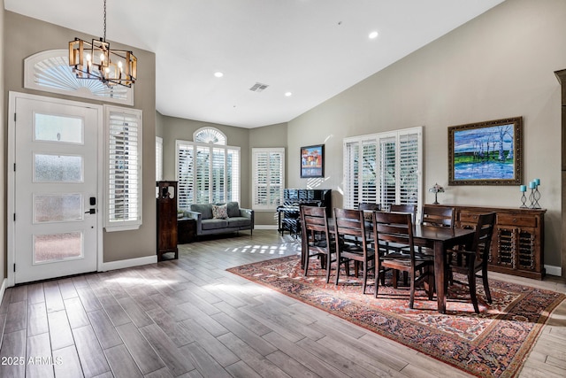 26475 N Wrangler Rd, Scottsdale, AZ 85255 - dining area with a chandelier, wood finished floors, high vaulted ceiling, and recessed lighting