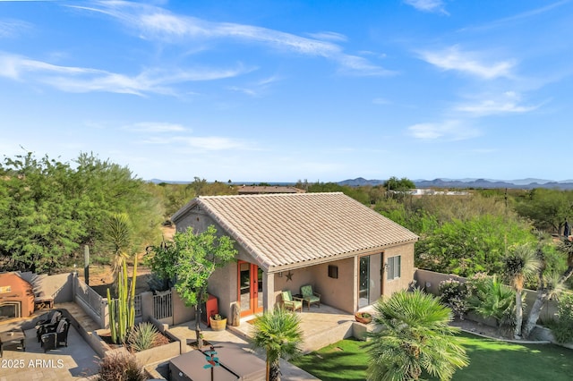 26475 N Wrangler Rd, Scottsdale, AZ 85255 - view of front of house with a tiled roof, a mountain view, a fenced backyard, a patio area, and stucco siding