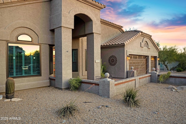26475 N Wrangler Rd, Scottsdale, AZ 85255 - view of front of home with stucco siding, a tile roof, and a garage