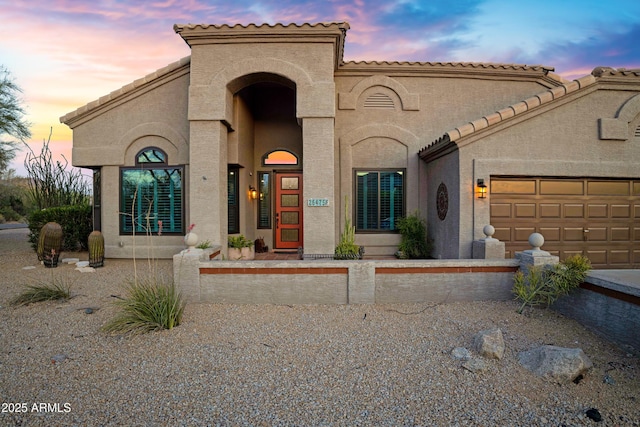 26475 N Wrangler Rd, Scottsdale, AZ 85255 - mediterranean / spanish house featuring an attached garage, stucco siding, and a tiled roof
