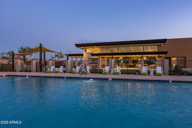 view of pool at dusk