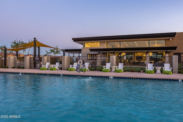 view of pool at dusk