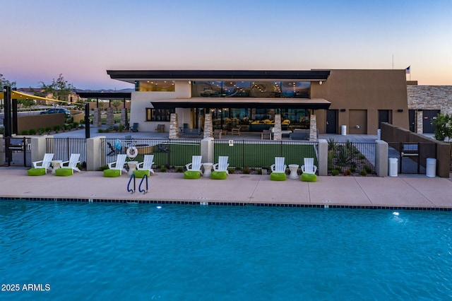 view of pool at dusk