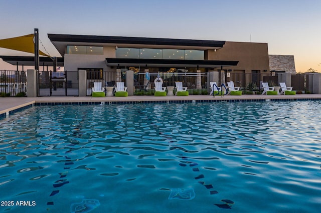 view of pool at dusk