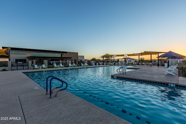 pool at dusk with a patio