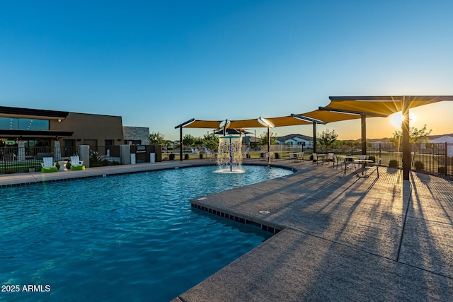 pool at dusk with pool water feature