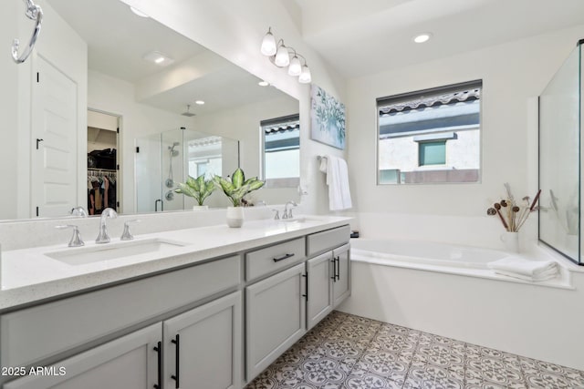 bathroom featuring shower with separate bathtub, tile patterned floors, and vanity