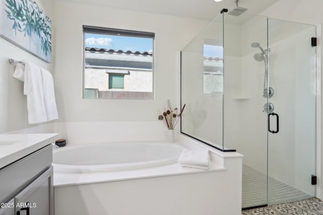 bathroom with vanity and separate shower and tub