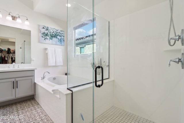 bathroom with vanity, tile patterned floors, and shower with separate bathtub