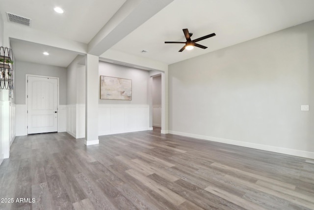 unfurnished living room featuring ceiling fan and light wood-type flooring