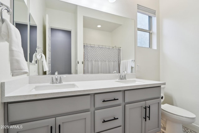 bathroom featuring vanity, curtained shower, and toilet