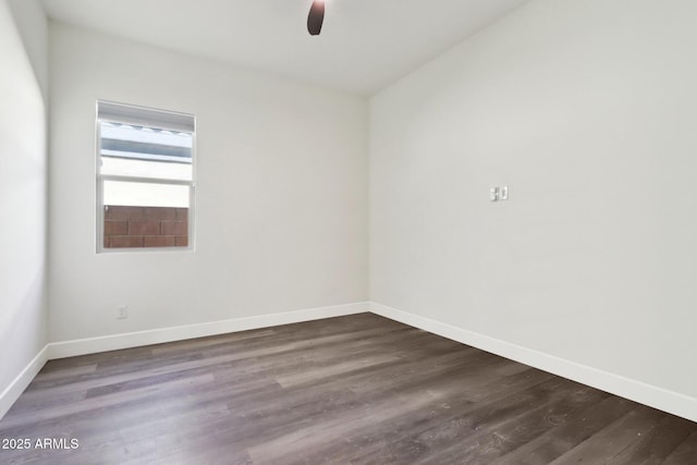 empty room featuring ceiling fan and dark hardwood / wood-style flooring