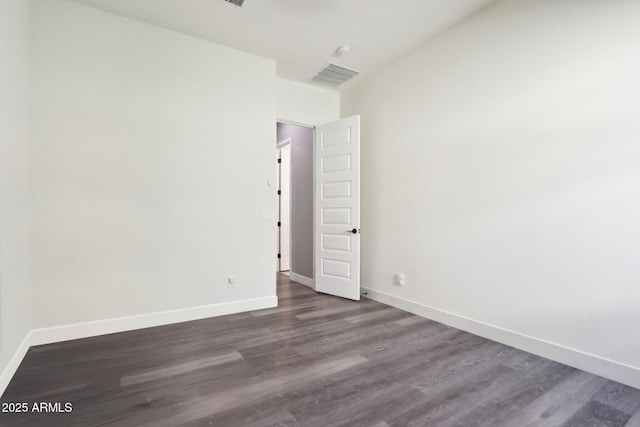 empty room featuring dark wood-type flooring