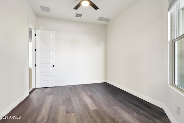 empty room featuring ceiling fan and dark hardwood / wood-style flooring