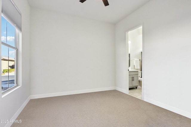 empty room with ceiling fan and light carpet