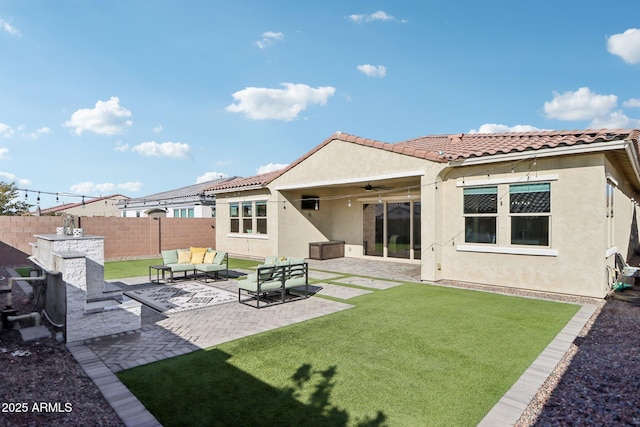 rear view of house with ceiling fan, a yard, outdoor lounge area, and a patio area