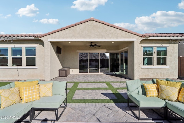 back of property with ceiling fan, an outdoor hangout area, and a patio area