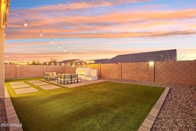 yard at dusk with outdoor lounge area and a patio area