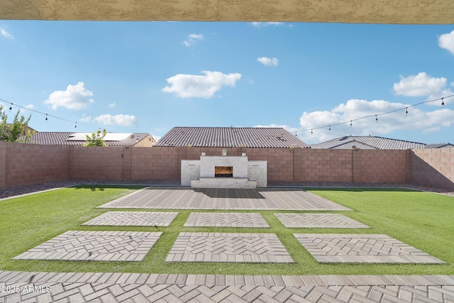 view of yard with a patio and an outdoor fireplace