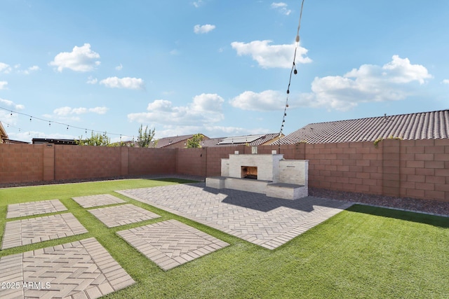 view of yard with an outdoor fireplace and a patio