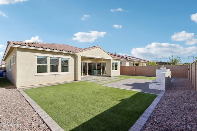 back of house featuring a yard and a patio area