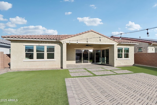 back of house featuring a yard, a patio area, and ceiling fan