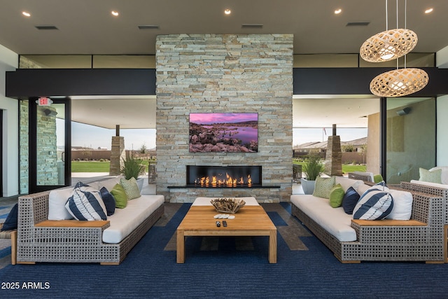 living room featuring an outdoor stone fireplace