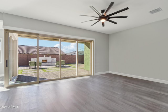 empty room featuring wood-type flooring and ceiling fan