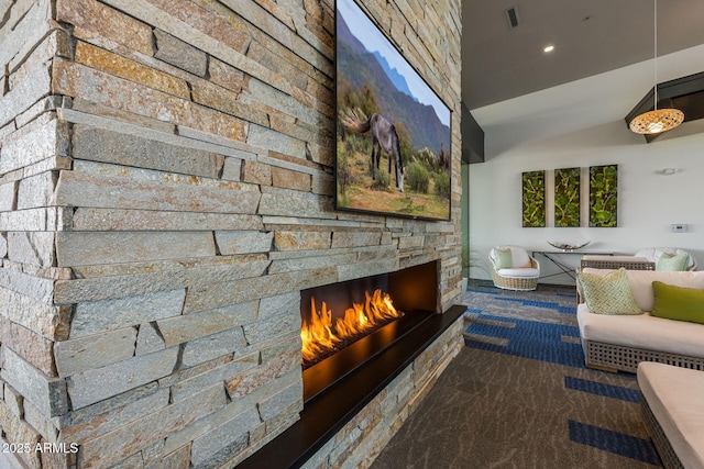 unfurnished living room featuring a stone fireplace and lofted ceiling