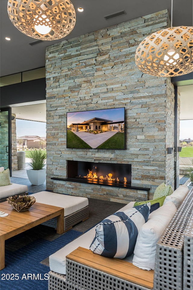 living room with an outdoor stone fireplace