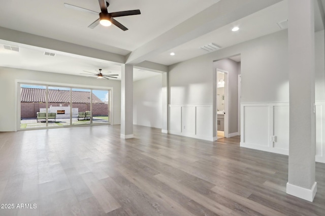 unfurnished living room with ceiling fan and light hardwood / wood-style floors