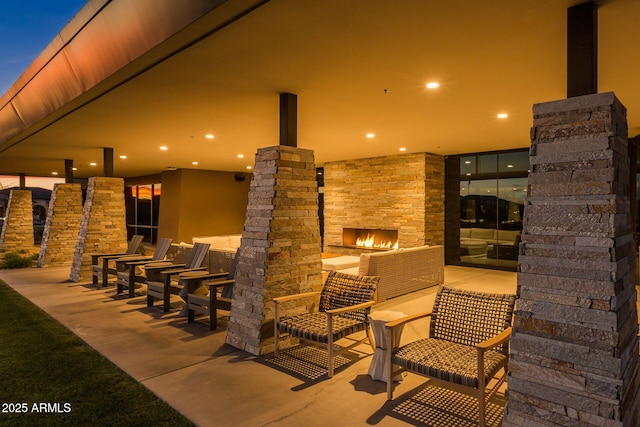 view of patio / terrace featuring an outdoor stone fireplace