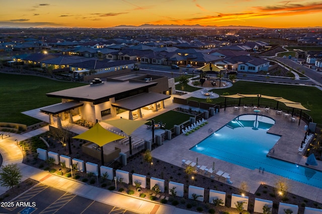 pool at dusk with a patio