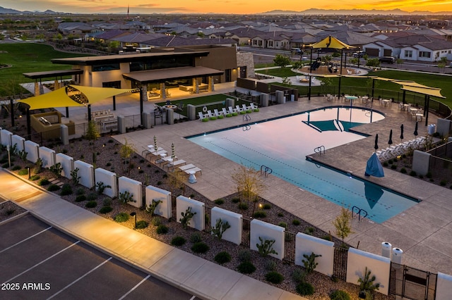 pool at dusk with a patio