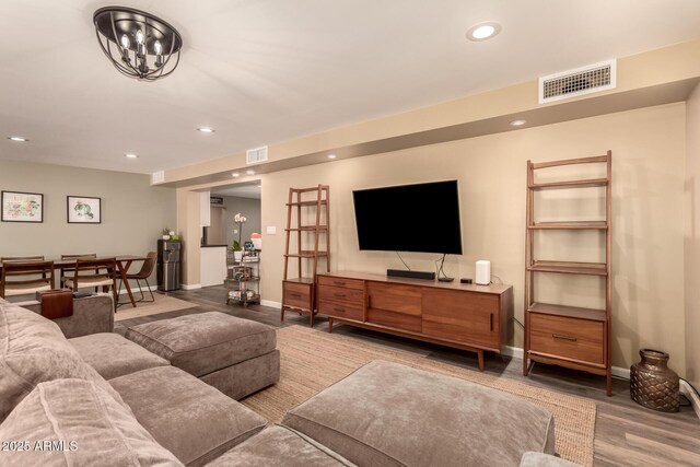 living room featuring a notable chandelier and hardwood / wood-style flooring