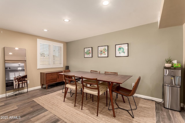 dining area with dark hardwood / wood-style flooring